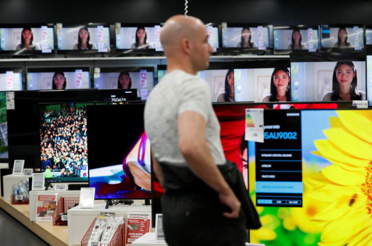 A man walks past television screens at consumer electronics retailer Media Markt in Budapest, Hungary, May 2, 2022.  