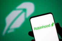 Robinhood logo is seen on a smartphone in front of a displayed same logo in this illustration taken, July 2, 2021. 