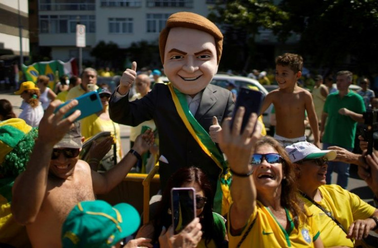 A supporter of Brazilian President Jair Bolsonaro impersonates him during a demonstration to show support for the president May 1, 2022