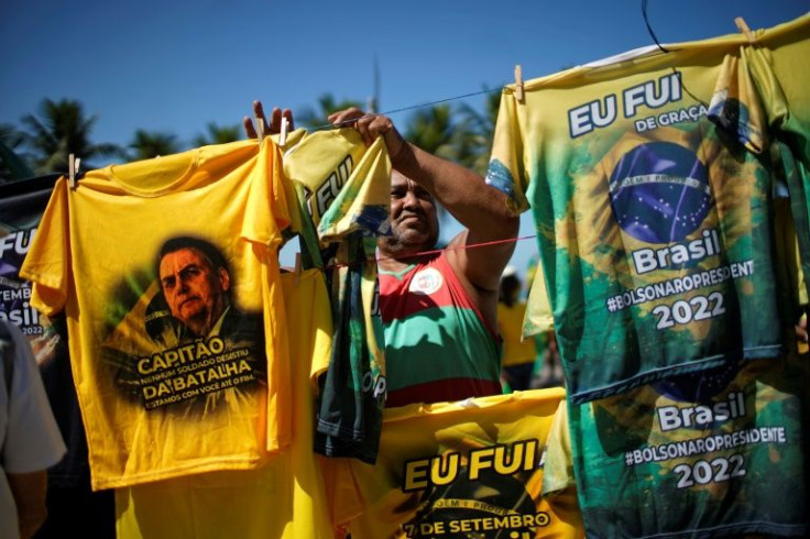 A vendor sells T-shirts as supporters of Brazilian President Jair Bolsonaro demonstrate May 1 , 2022