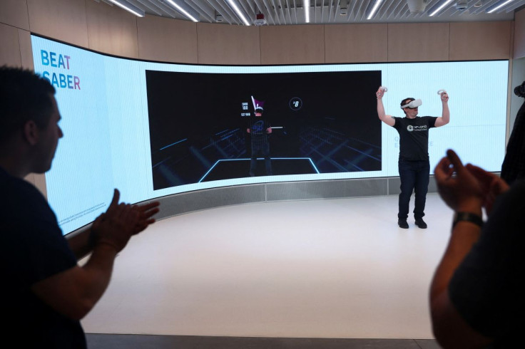 A person plays Beat Saber in the Quest Experience during a preview of the inaugural physical store of Facebook-owner Meta Platforms Inc in Burlingame, California, U.S. May 4, 2022.  