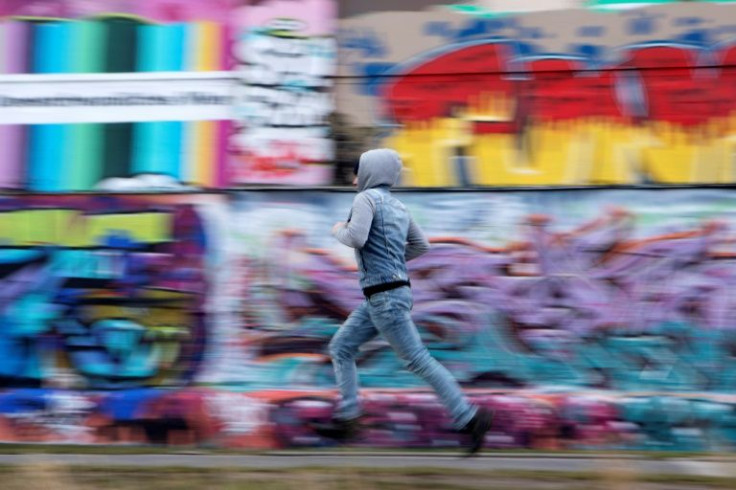 Never safe: A young Chechen exile runs past a wall near the Danube Canal in Vienna