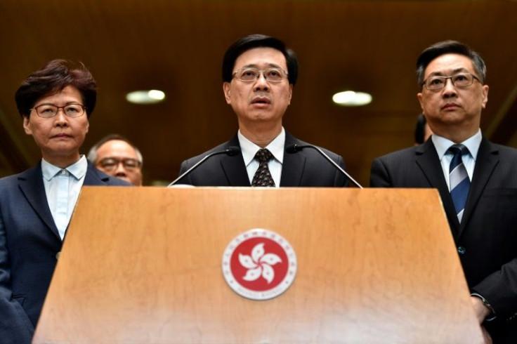 Insiders say the unwavering commitment of John Lee (C) to the suppression of pro-democracy protests won China's confidence at a time when other Hong Kong elite were seen as insufficiently loyal or competent