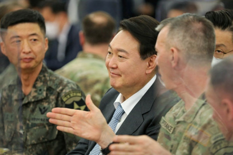 South Korea's president-elect Yoon Suk-yeol talks with military officials during his visit to U.S. Army Garrison Humphreys in Pyeongtaek, South Korea, April 7, 2022. U.S. Forces Korea/Yonhap via 