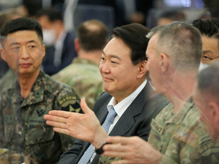 South Korea's president-elect Yoon Suk-yeol talks with military officials during his visit to U.S. Army Garrison Humphreys in Pyeongtaek, South Korea, April 7, 2022. U.S. Forces Korea/Yonhap via 