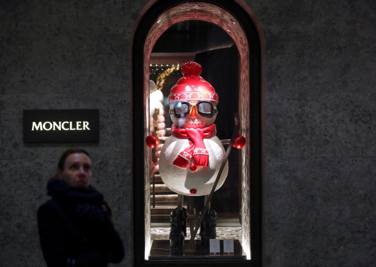 A woman walks past Moncler's flagship store in Montenapoleone street downtown Milan, Italy December 8, 2017.