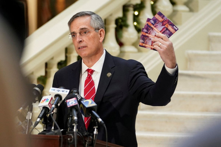 Georgia's Secretary of State Brad Raffensperger holds up election mail that he said arrived for his son, who is deceased, during a news conference on election results in Atlanta, Georgia, U.S., December 2, 2020.  
