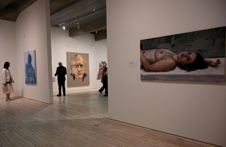People browse around a display of some of the finalists for the Archibald Prize