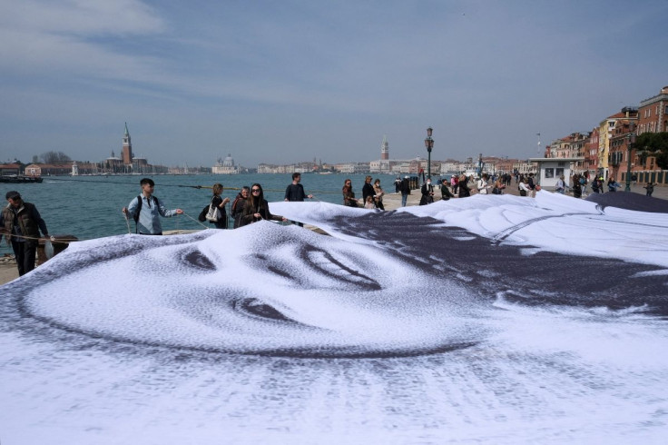 A giant photograph of a young Ukrainian refugee is unveiled as part of an art installation by French contemporary artist JR to show solidarity with Ukraine, amid Russia's invasion, in Venice, Italy, April 13, 2022.