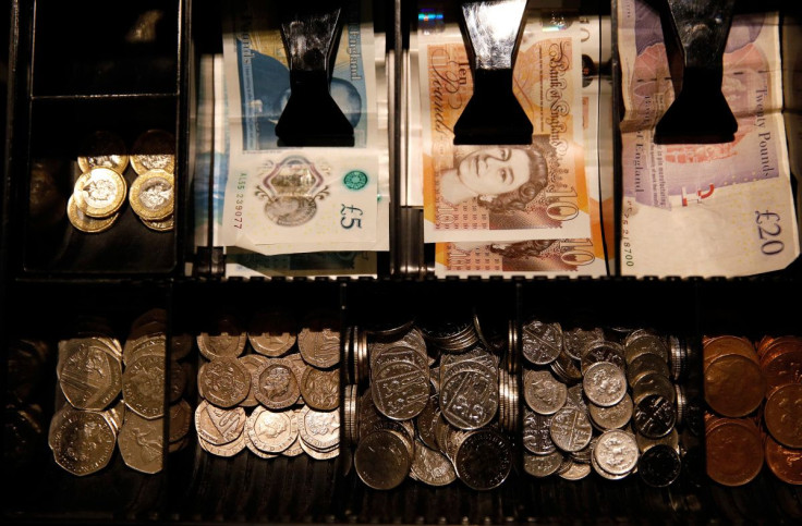 Pound Sterling notes and change are seen inside a cash resgister in a coffee shop in Manchester, Britain, Septem,ber 21, 2018. 