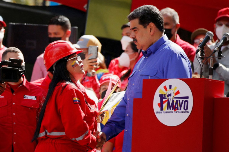 Venezuela's President Nicolas Maduro shakes hands with a state oil company PDVSA worker during the May Day celebrations in Caracas, Venezuela May 1, 2022. 