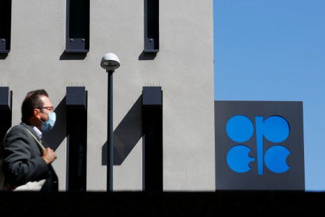 A person passes the logo of the Organization of the Petroleoum Exporting Countries (OPEC) in front of OPEC's headquarters in Vienna, Austria April 9, 2020.  