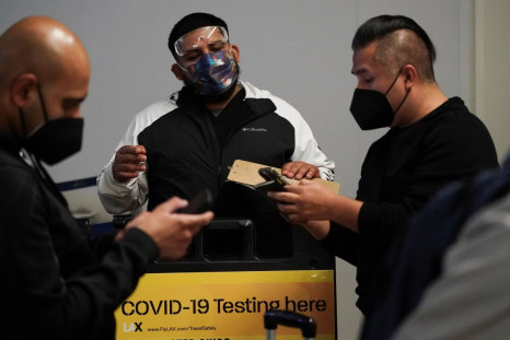 Travelers wait in line to get tests for the coronavirus disease (COVID-19) at a pop-up clinic at Tom Bradley International Terminal at Los Angeles International Airport, California, U.S., December 22, 2021. 