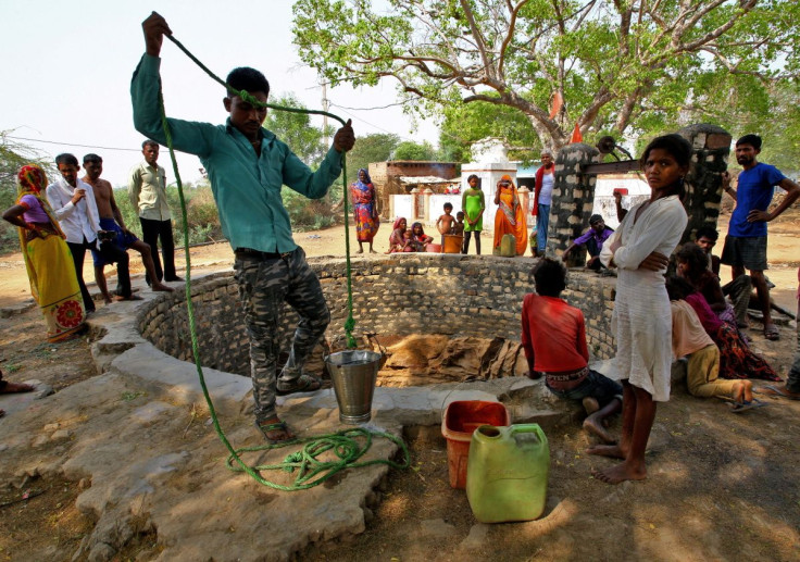 A man fetches water from an almost dry well on a hot day in Badama village in the northern state of Uttar Pradesh, India, May 4, 2022.