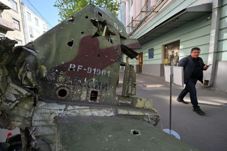 A pedestrian walks past the wreckage of a Russian plane outside the National Museum of Military History of Ukraine in Kyiv.