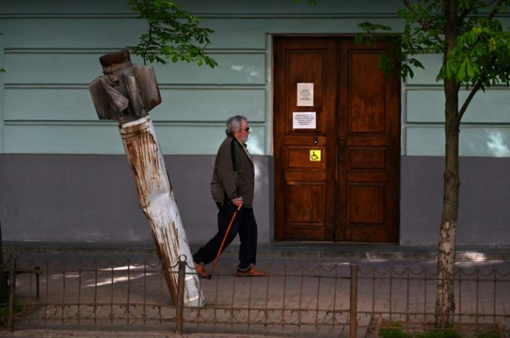 A pedestrian walks past a Russian rocket outside the National Museum of Military History of Ukraine in Kyiv.