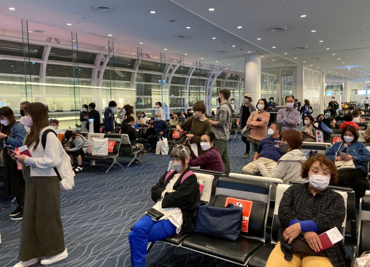 Travelers line up to board a Hawaii-bound flight from Tokyo's Haneda International Airport during Japan's "Golden Week" holidays, in Tokyo, Japan April 29, 2022.
