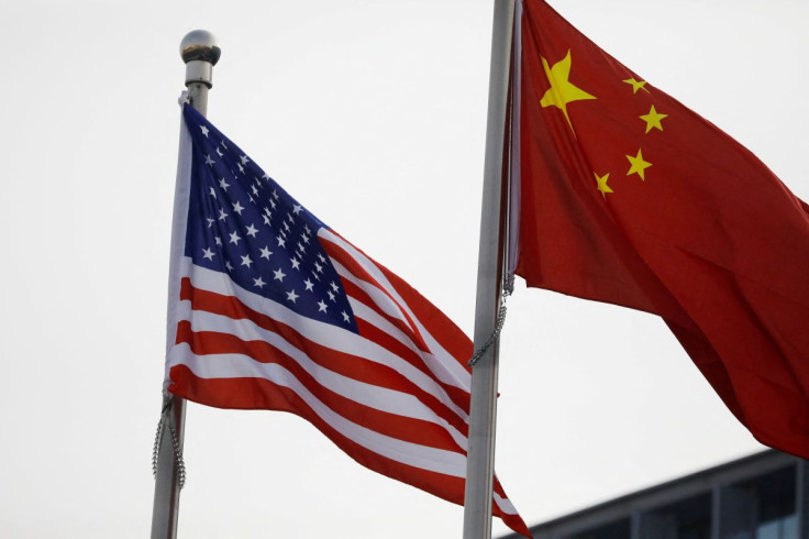 Chinese and U.S. flags flutter outside the building of an American company in Beijing, China January 21, 2021. 