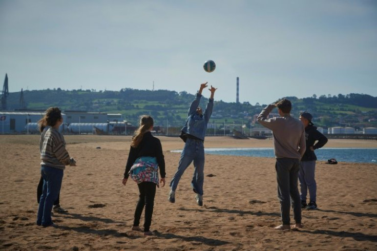 The Pavlosky family play volleyball at a beach in Gijon, northern Spain, where they have found a safe haven from the Ukraine war