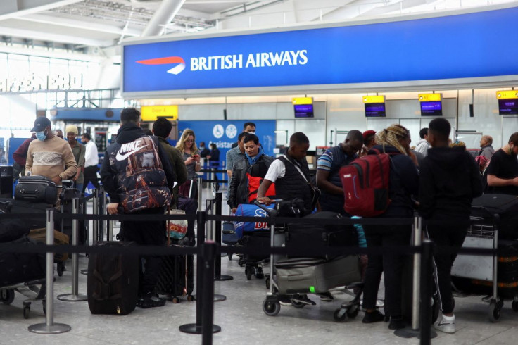 Passengers queue for airport check-in ahead of the Easter Bank Holiday weekend, at Heathrow Airport, in London, Britain, April 14, 2022. 