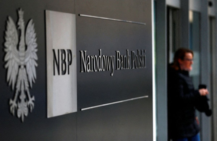 A woman walks out from the National Bank of Poland headquarters in Warsaw March 4, 2015.  