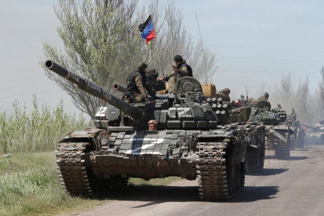 Service members of pro-Russian troops drive armoured vehicles during Ukraine-Russia conflict near Novoazovsk in the Donetsk Region, Ukraine May 6, 2022. 