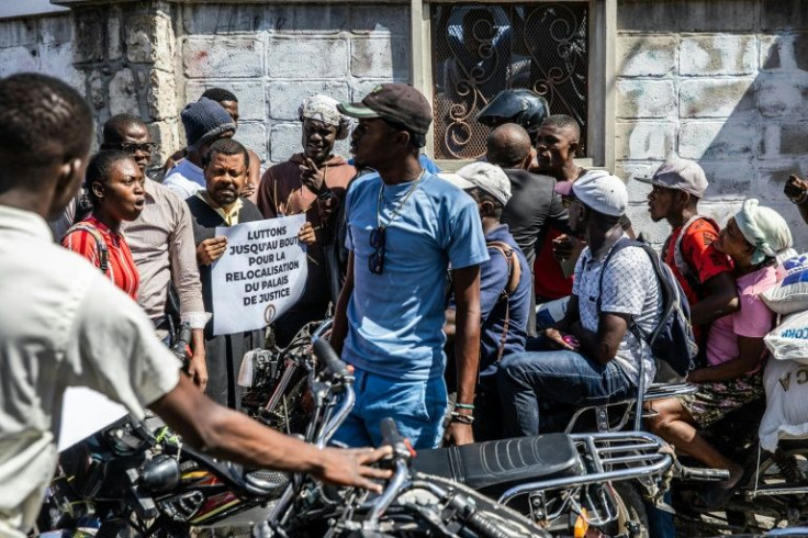 Lawyers block a street as they protest outside of Prime Minister Ariel Henryâs private home to force the government to relocate the civil court to a safer area, in Port-au-Prince, Haiti in April, 2022