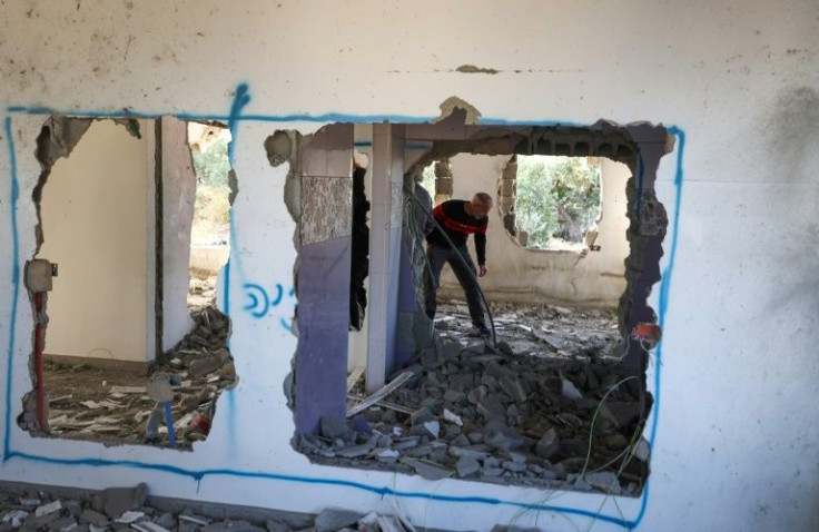 A Palestinian man inspects the home of Omar Jaradat demolished by Israeli security forces after they accused him of killing a Jewish settler