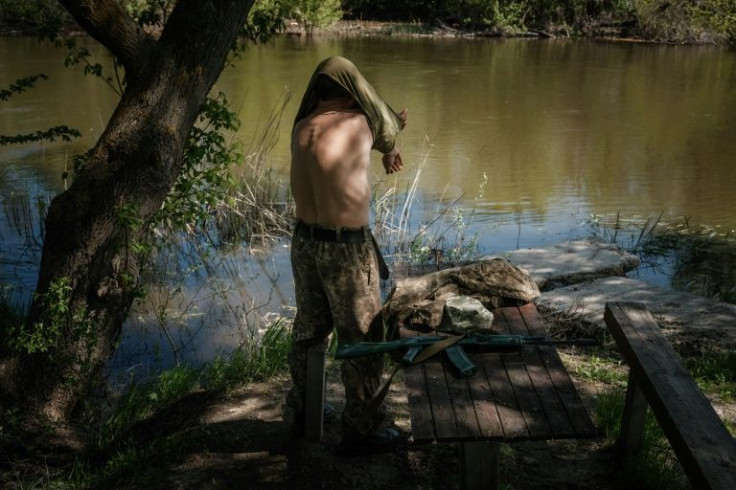 Some Ukrainian soldiers try to relieve the stress by taking dips in a key river separating their positions from the Russians