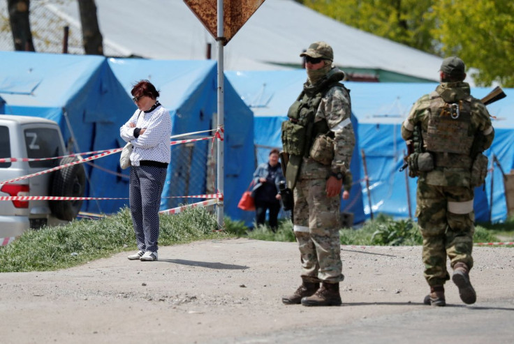 Service members of pro-Russian troops stand guard on a road near a temporary accommodation centre during Ukraine-Russia conflict in the village of Bezimenne in the Donetsk region, Ukraine May 7, 2022. 