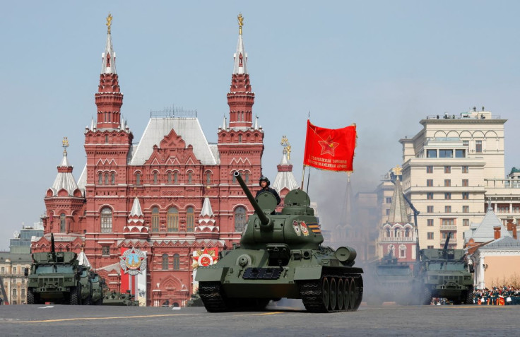 A T-34 Soviet-era tank and Typhoon all-terrain armoured vehicles drive in Red Square during a rehearsal for a military parade marking the anniversary of the victory over Nazi Germany in World War Two in central Moscow, Russia May 7, 2022. 