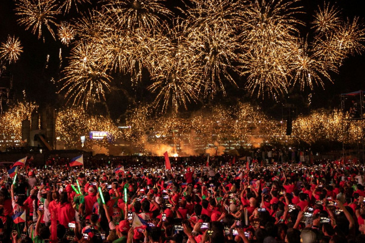 Supporters of presidential candidate Ferdinand "Bongbong" Marcos Jr., the son and namesake of the late Philippine dictator, and Vice-presidential candidate Sara Duterte-Carpio, daughter of Philippine President Rodrigo Duterte, watch a fireworks display du