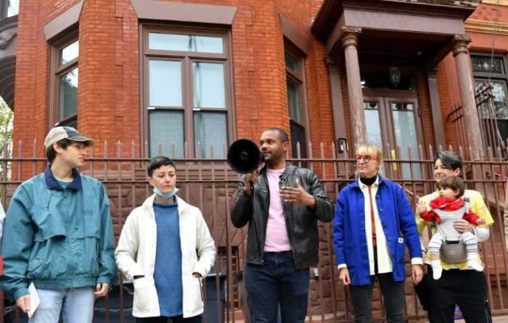 New York State Senator Jabari Brisport (C) speaks to protesters demonstrating against rent increases in April 2022 in Brooklyn