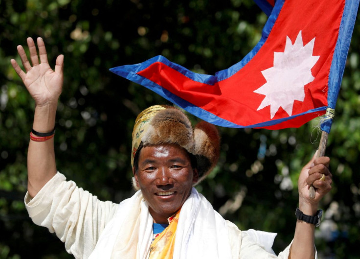 Kami Rita Sherpa, a Nepali mountaineer, waves towards media in Kathmandu, Nepal May 25, 2019. Kami Rita summited Mount Everest on May 7, 2022, for a record 26th time, beating his own record set last year,