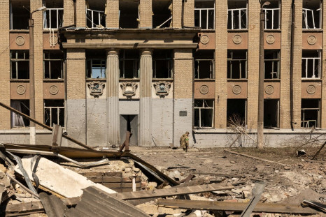 A Ukrainian soldier walks in front of a school that was bombed amid Russia's invasion in Ukraine, in Kostyantynivka, in the Donetsk region, Ukraine, May 8, 2022. 