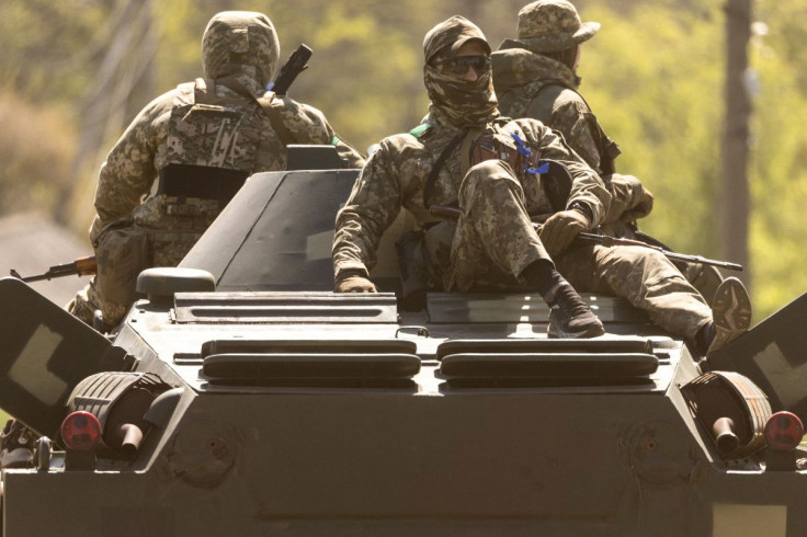 Ukrainian soldiers ride on an armored vehicle enroute to the front line, amid Russia's invasion in Ukraine, in Bakhmut in the Donetsk region, Ukraine, May 8, 2022. 