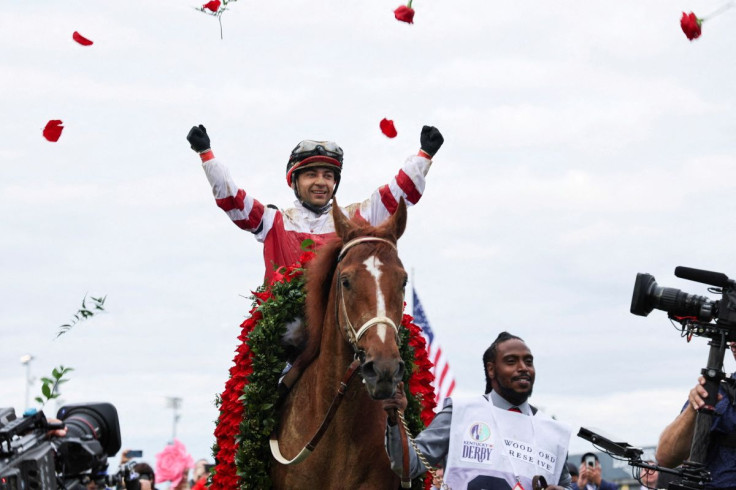 Jockey Sonny Leon throws roses in celebration after the win of Rich Strike at the 148th Kentucky Derby, at Churchill Downs in Louisville, Kentucky, U.S. May 7, 2022. 