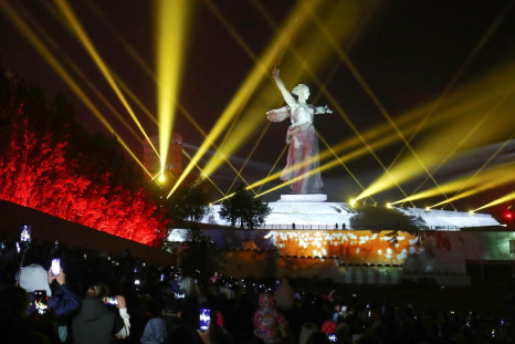 People gather in front of the illuminated Motherland Calls monument during a ceremony ahead of Victory Day, which marks the 77th anniversary of the victory over Nazi Germany in World War Two, at the Mamayev Kurgan memorial in Volgograd, Russia May 7, 2022