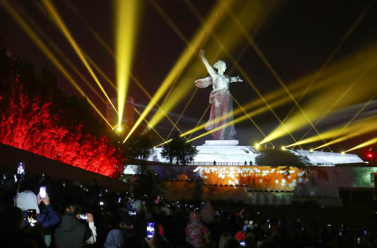 People gather in front of the illuminated Motherland Calls monument during a ceremony ahead of Victory Day, which marks the 77th anniversary of the victory over Nazi Germany in World War Two, at the Mamayev Kurgan memorial in Volgograd, Russia May 7, 2022