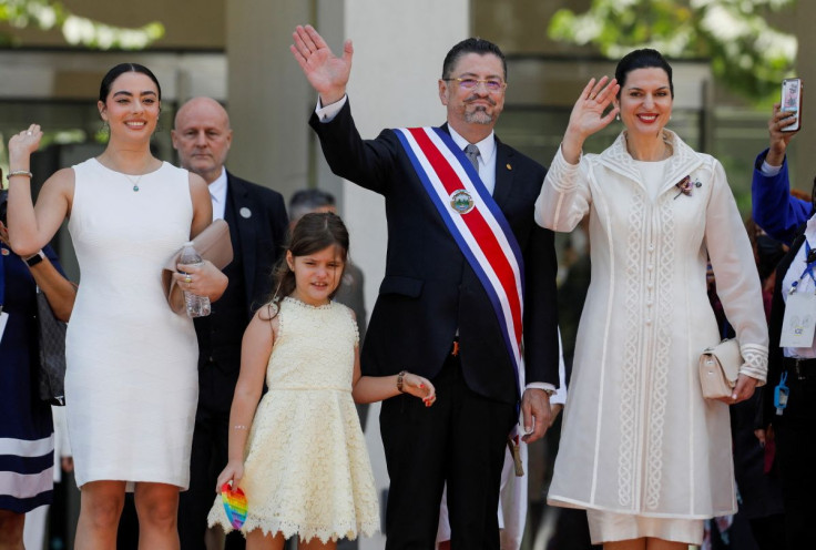 Rodrigo Chaves waves with his daughters, Tatiana Chaves, Isabella Chaves, and his wife Signe Zeicate after his swearing-in ceremony as Costa Rica's new President outside the Legislative Assembly building, in San Jose, Costa Rica May 8, 2022.
