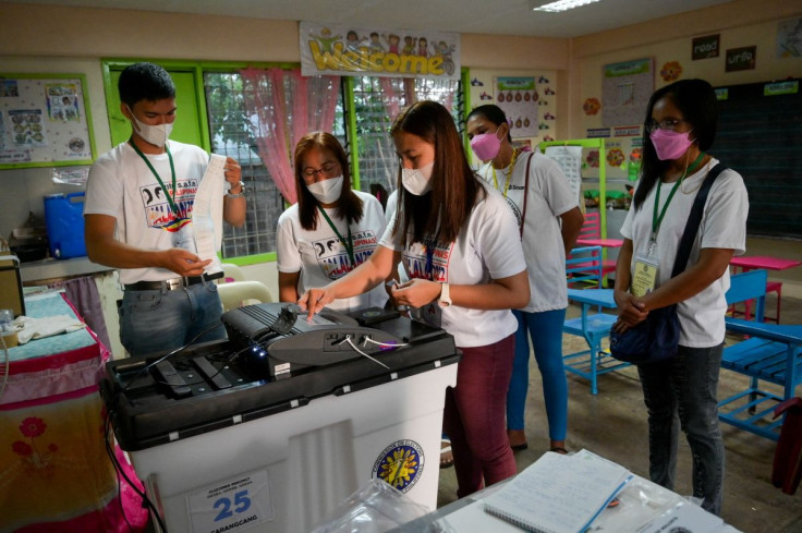 Teachers and volunteers prepare the voting precinct for the national election, in Magarao, Camarines Sur, Philippines, May 9, 2022. 