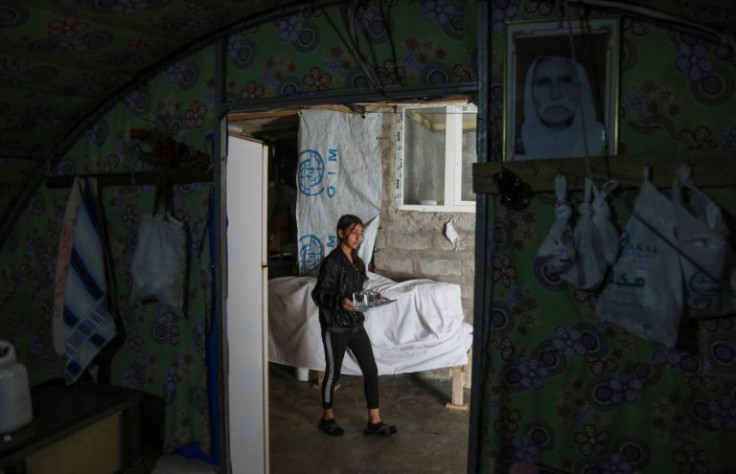 A displaced Yazidi girl walks in a tent at the Chamishko camp in the city of Zakho, where members of the community fled after a recent surge in violence