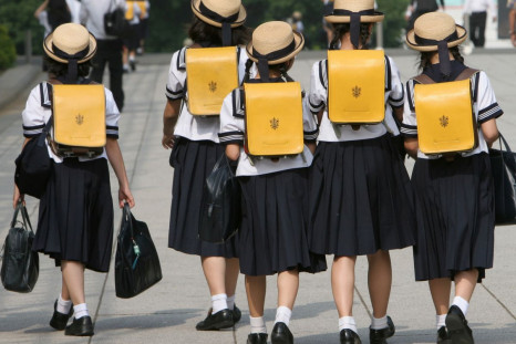 Children walk on their way back from school in Tokyo June 30, 2006.   