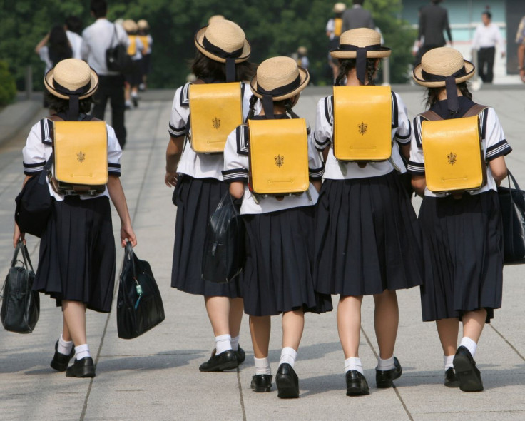 Children walk on their way back from school in Tokyo June 30, 2006.   