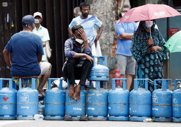 People block a main road as they wait for the gas trucks to arrive at the station to distribute for them, amid the country's economic crisis in Colombo, Sri Lanka, May 8, 2022. 