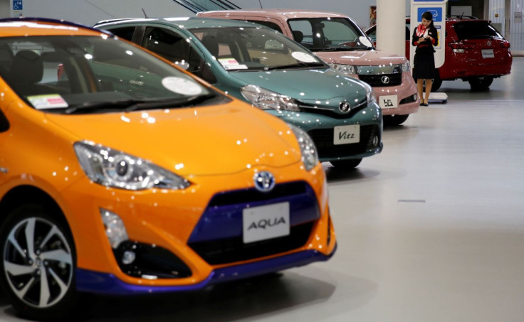 An employee stands among Toyota Motor Corp's cars at the company's showroom in Tokyo, Japan, May 11, 2016.