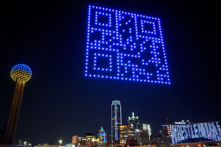 A QR Code is formed by drones as an April Fool's day prank, in the night sky above the Reunion Tower lawn, in Dallas, Texas, U.S., March 31, 2022.   Sky Elements Drone Shows/Handout via REUTERS  