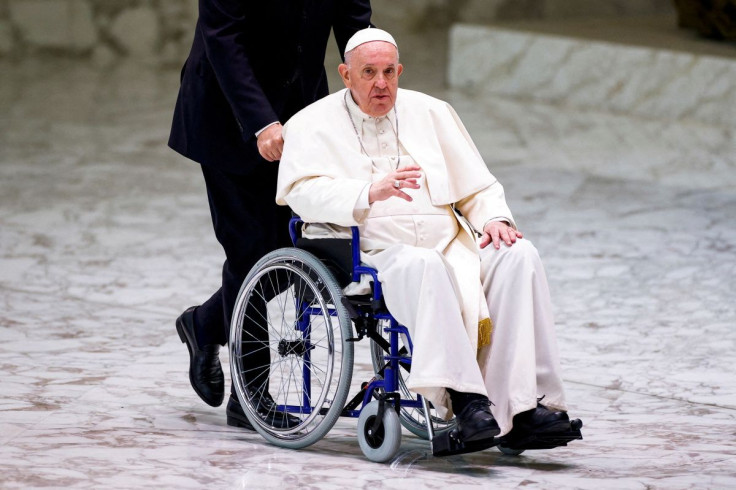 Pope Francis arrives on a wheelchair to meet with participants in the plenary assembly of the International Union of Superiors General (IUSG) at the Vatican, May 5, 2022. 