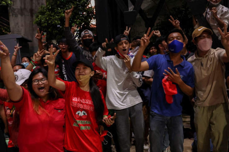 Supporters of presidential candidate Ferdinand "Bongbong" Marcos Jr. celebrate as partial results of the 2022 national elections show him with a wide lead over rivals, outside the candidate's headquarters in Mandaluyong City, Philippines, May 9, 2022.