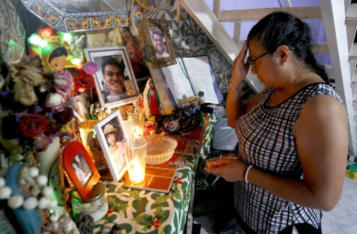Rosaura Magana prays for the safe return of her missing son Carlos Eduardo at her home in western Mexico